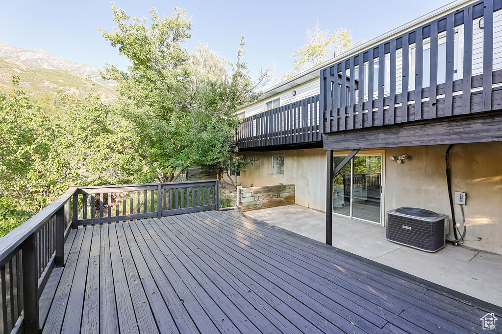 Deck featuring a patio and a mountain view