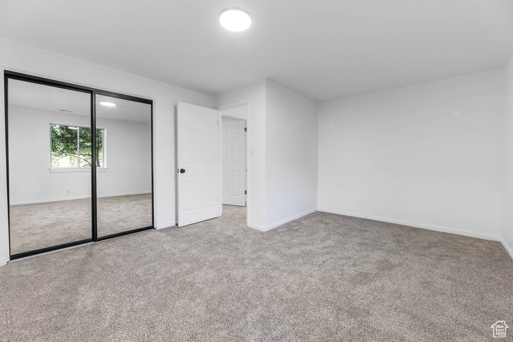 Unfurnished bedroom with carpet floors and a closet