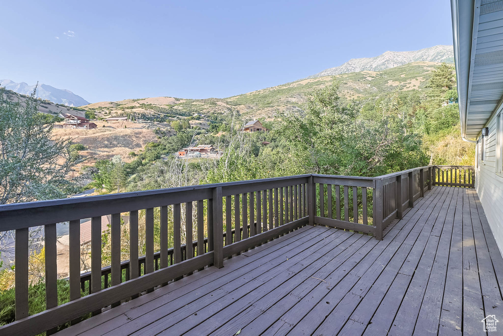 Wooden terrace featuring a mountain view