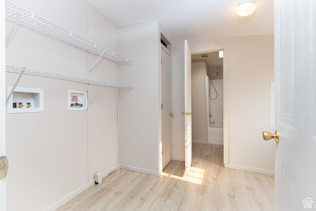 Washroom featuring wood finished floors and washer hookup