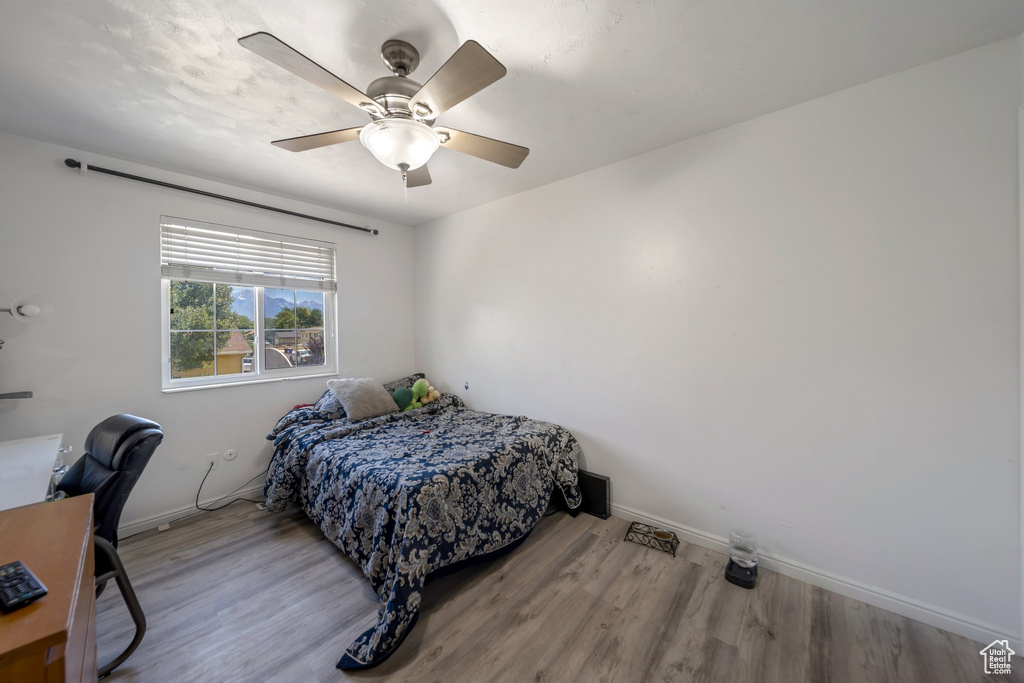Bedroom with wood finished floors and ceiling fan