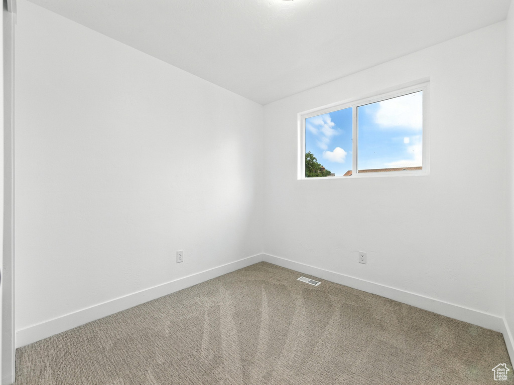 Unfurnished room with baseboards and carpet floors
