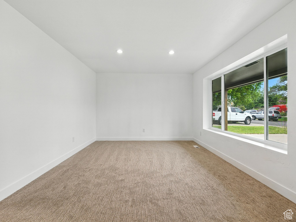 Spare room with recessed lighting and light carpet