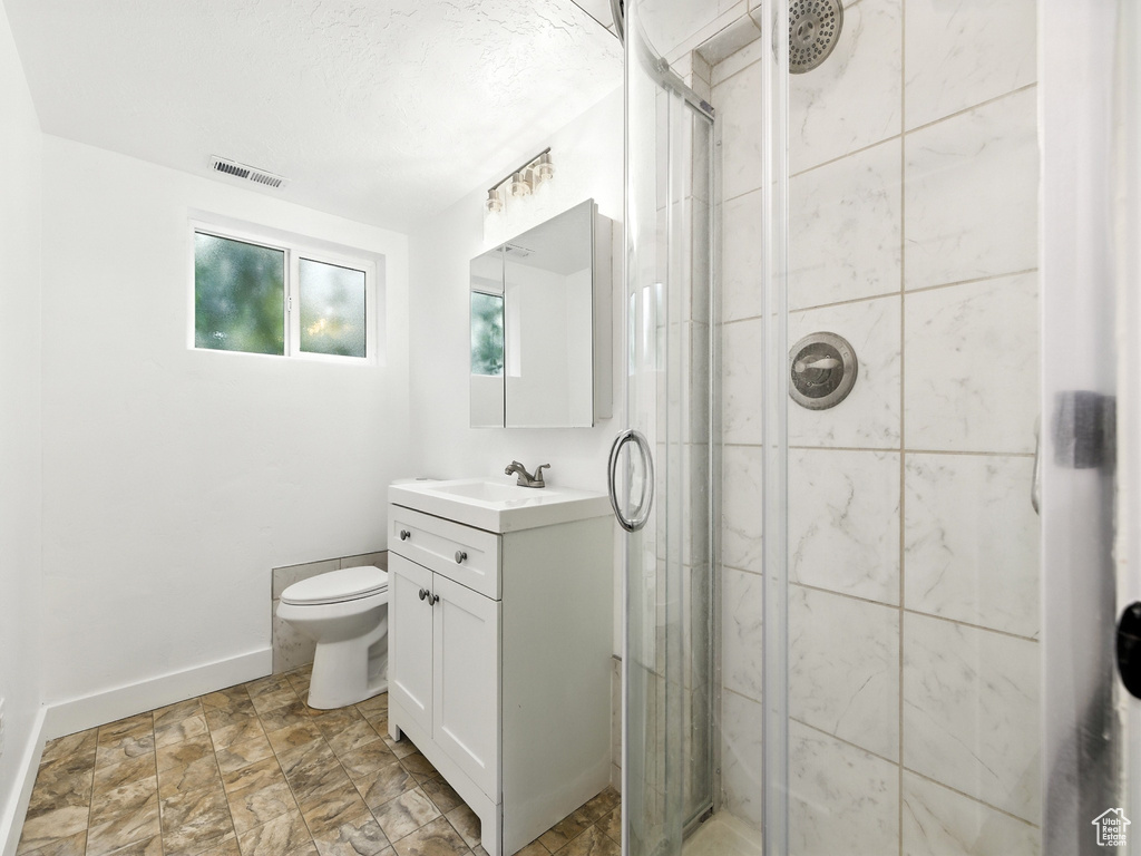 Bathroom with vanity and a shower stall