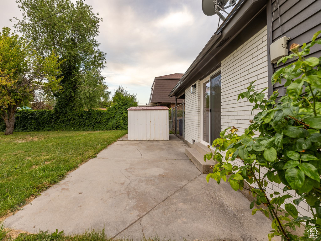 View of patio / terrace featuring a shed
