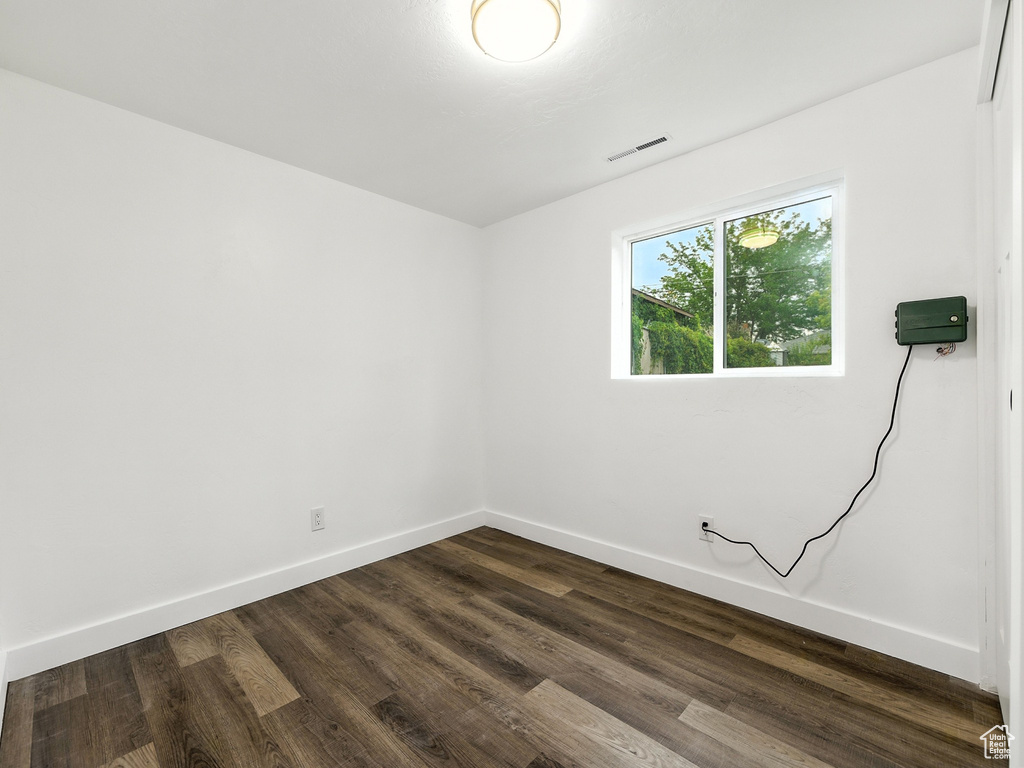 Unfurnished room featuring dark wood-style floors