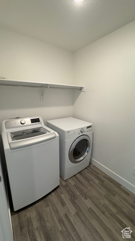 Laundry area with separate washer and dryer and dark wood-type flooring