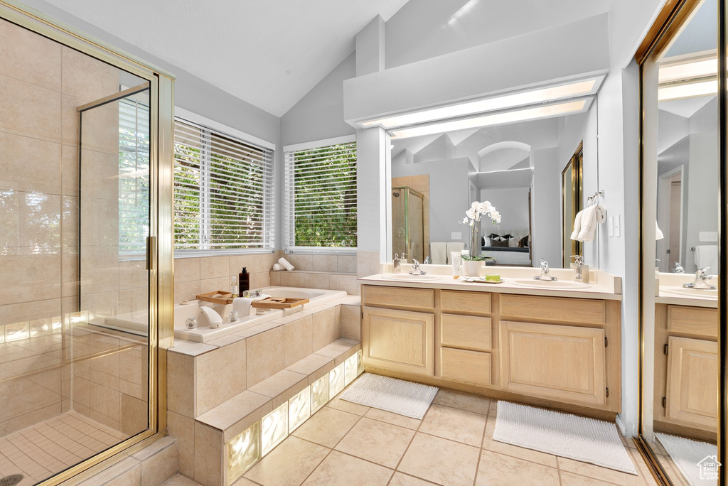 Bathroom with a bath, double vanity, a stall shower, and high vaulted ceiling