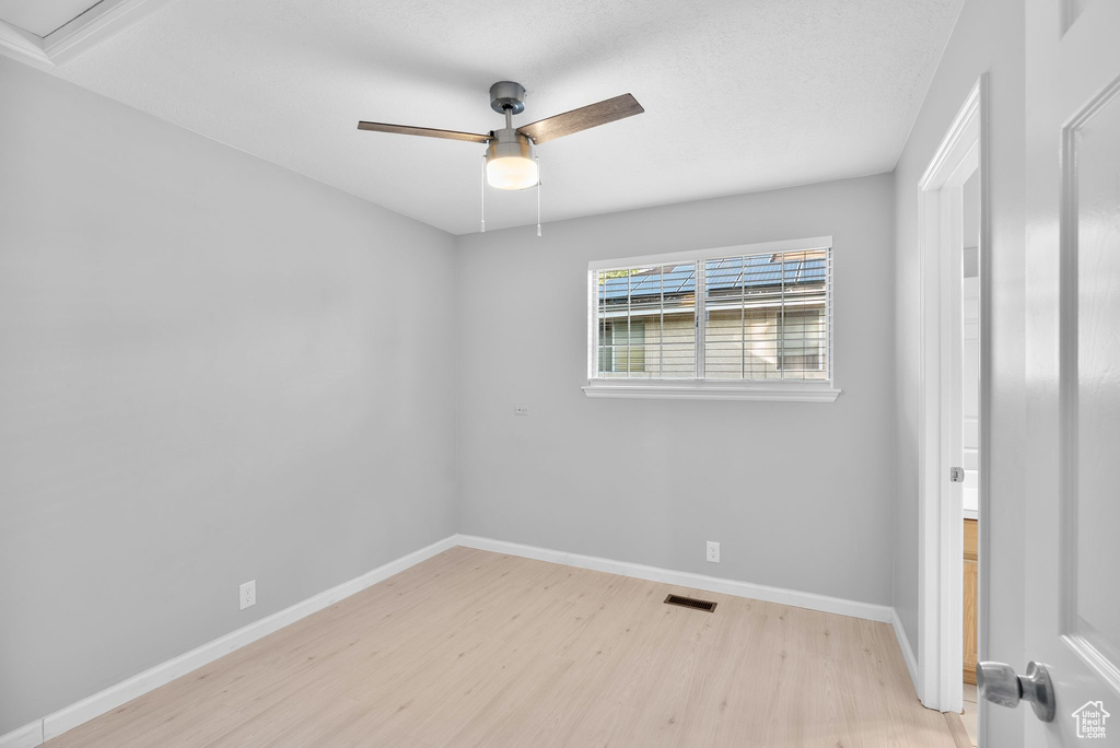 Unfurnished bedroom with light wood-type flooring and ceiling fan