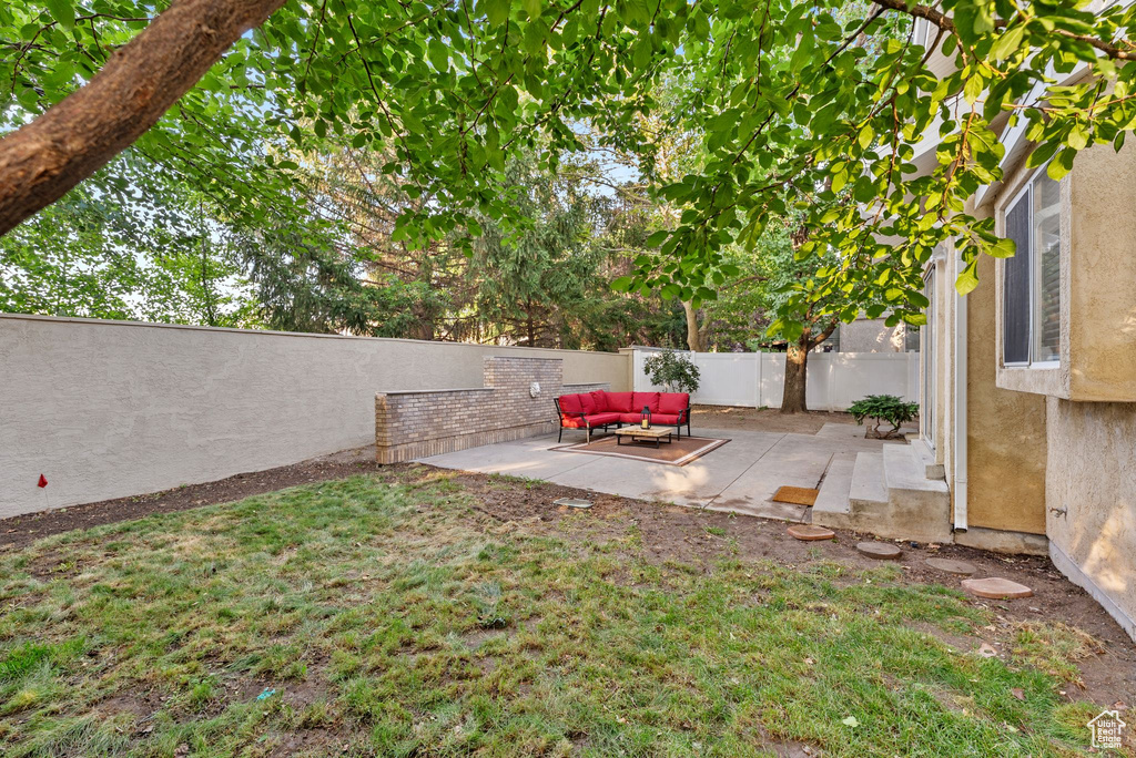 Fenced backyard featuring a patio and outdoor lounge area