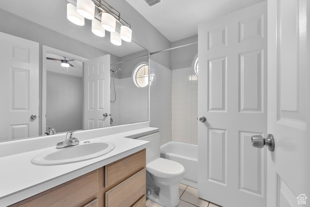 Bathroom with vanity, tile patterned flooring, and bathing tub / shower combination
