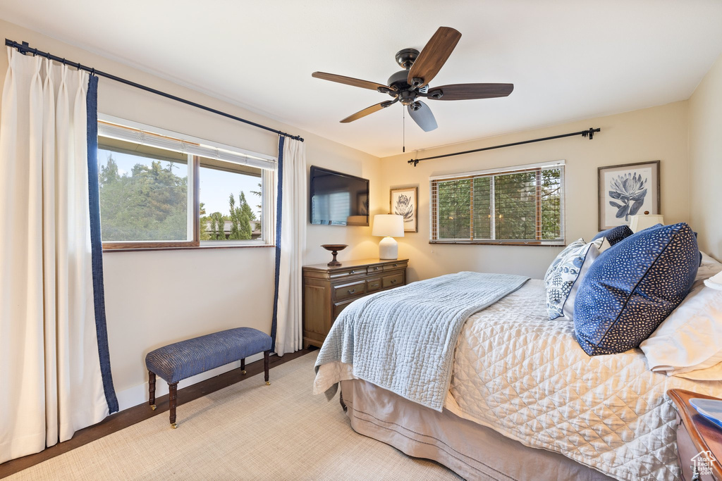 Carpeted bedroom featuring ceiling fan