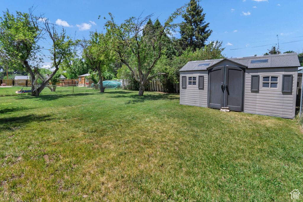 Fenced backyard with a storage shed