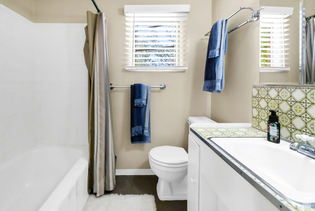 Full bath featuring vanity and shower / tub combo with curtain