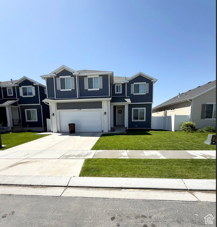 Traditional-style house featuring driveway and an attached garage