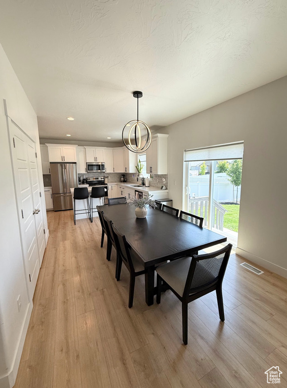 Dining space featuring light wood-type flooring and recessed lighting