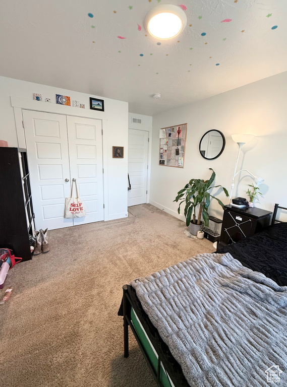 Bedroom with carpet flooring and baseboards