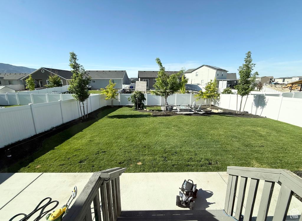 Fenced backyard with a residential view and a patio
