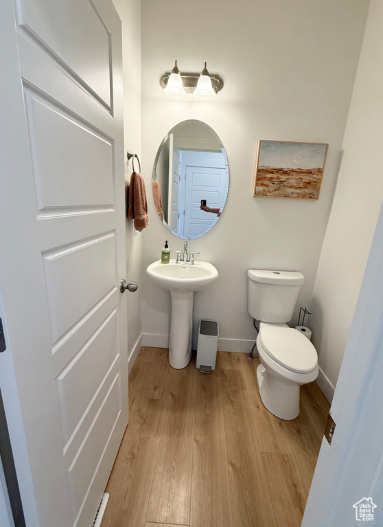 Bathroom featuring baseboards and wood finished floors