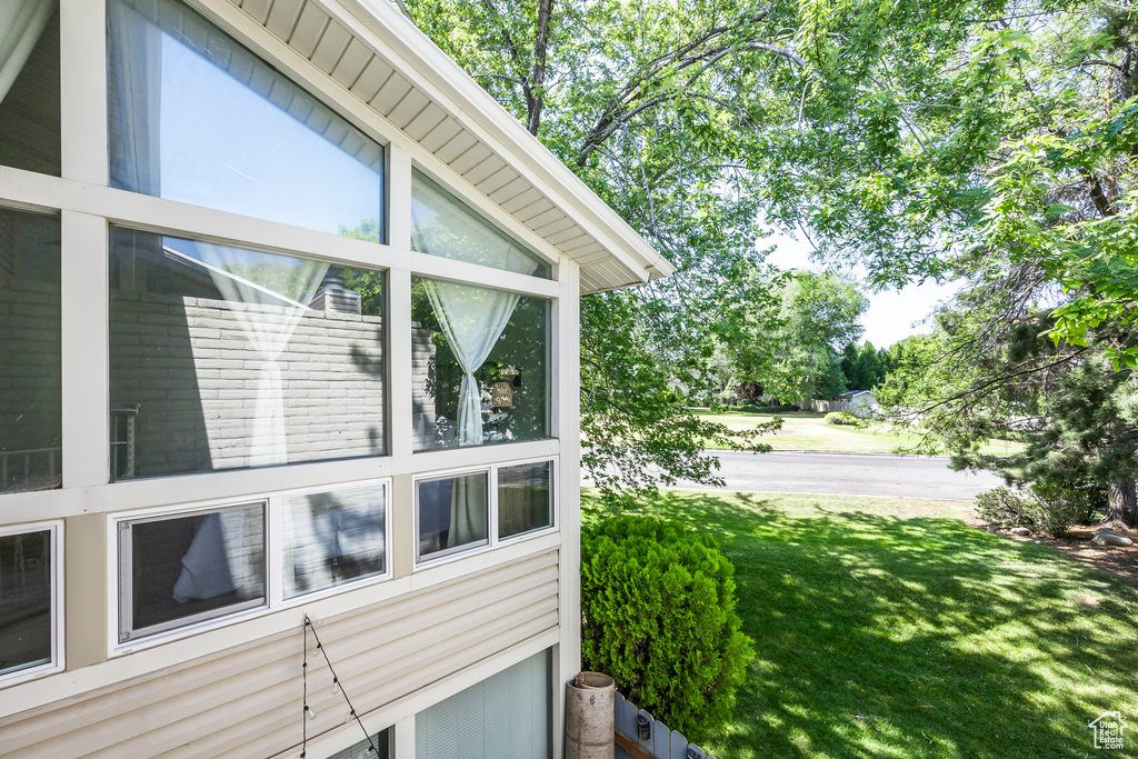 View of side of home featuring a yard