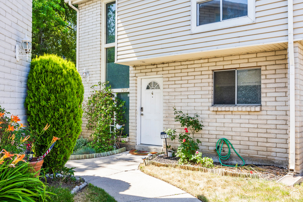 View of exterior entry featuring brick siding