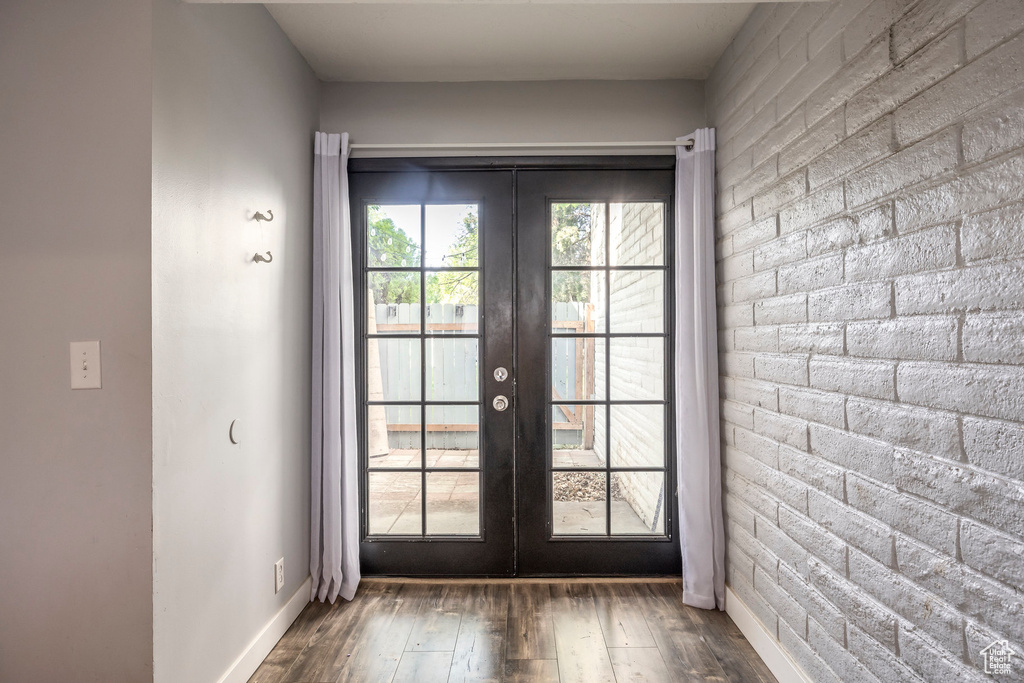 Doorway with french doors and wood-type flooring