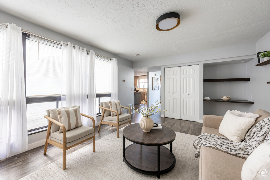 Living area featuring a textured ceiling and wood finished floors