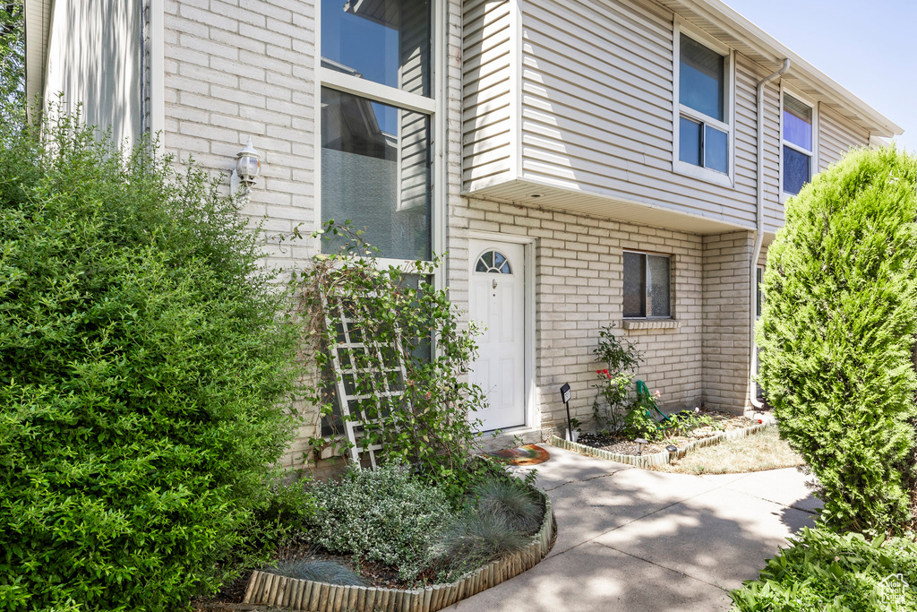 Doorway to property with brick siding