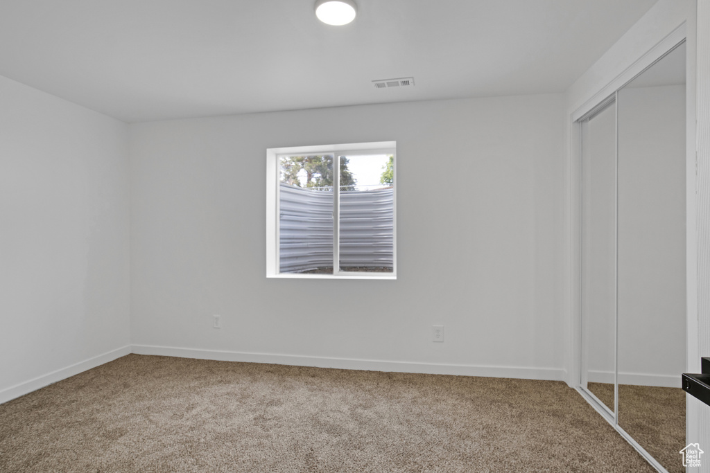 Unfurnished bedroom with carpet floors and a closet