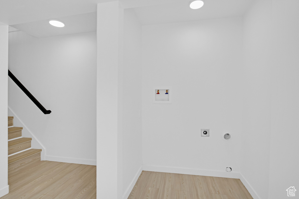 Laundry room featuring wood finished floors, hookup for a washing machine, electric dryer hookup, and recessed lighting