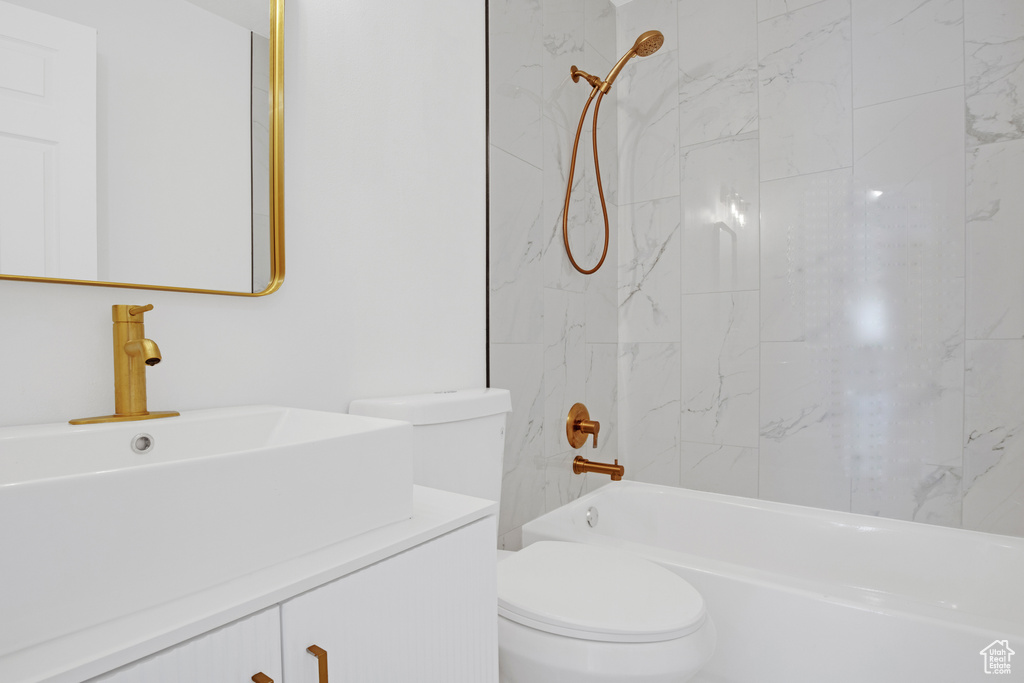 Bathroom with vanity and bathing tub / shower combination