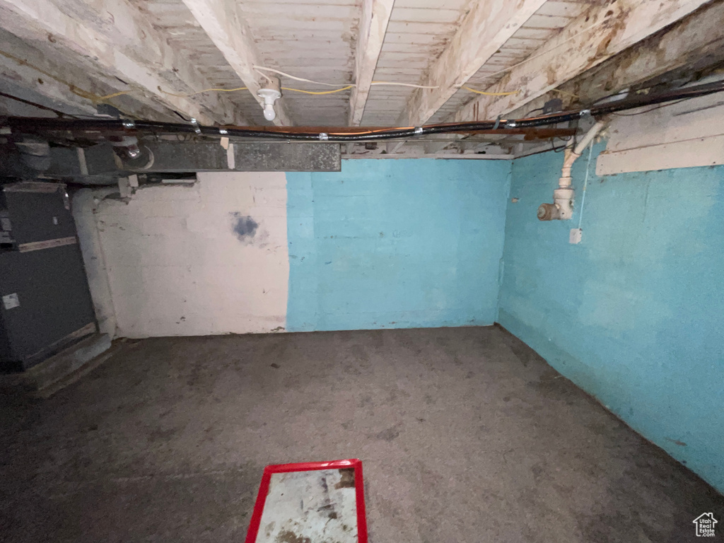 Unfinished basement featuring heating unit