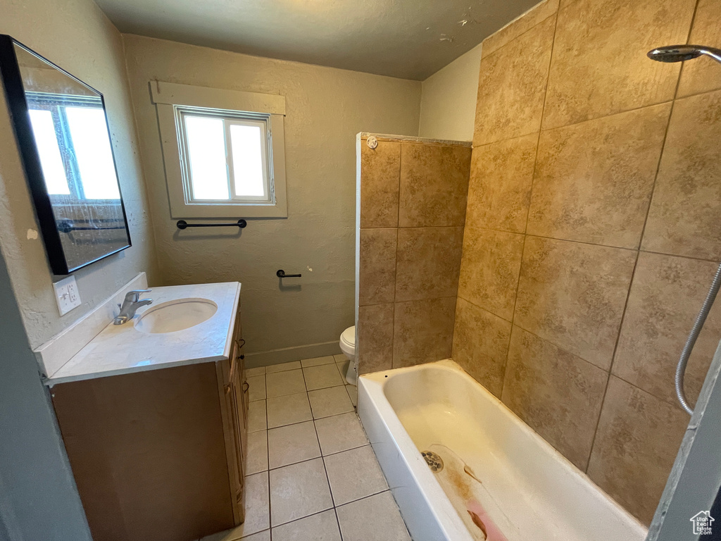Bathroom featuring tile patterned flooring, vanity, and bathtub / shower combination