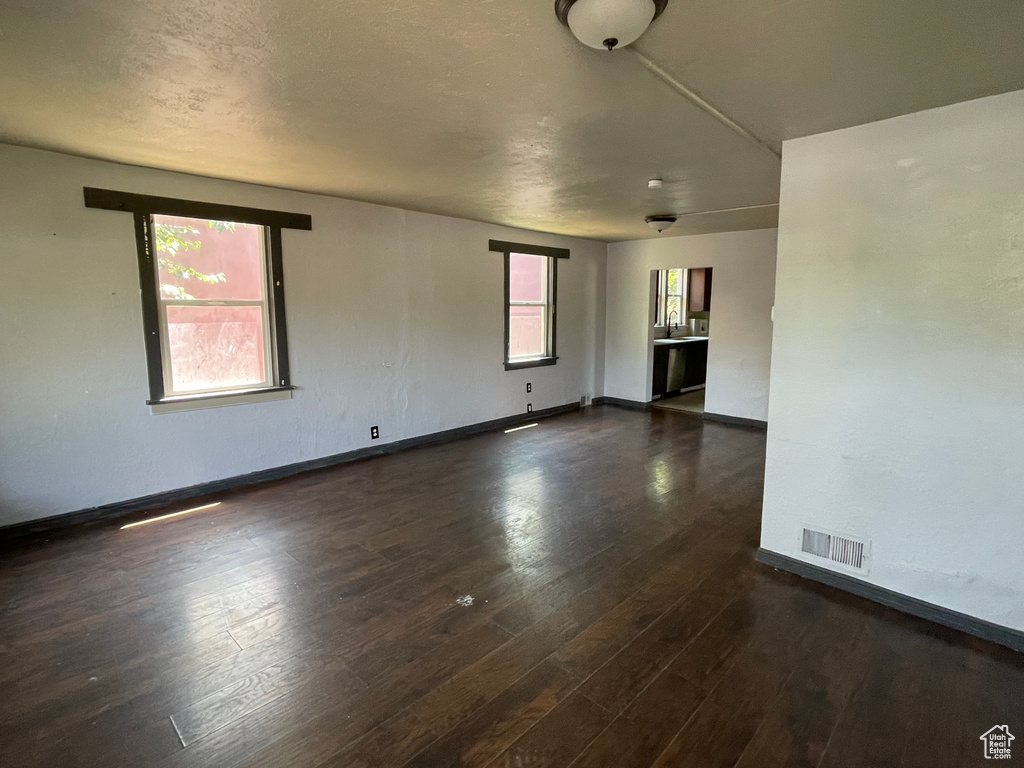 Empty room with dark wood finished floors