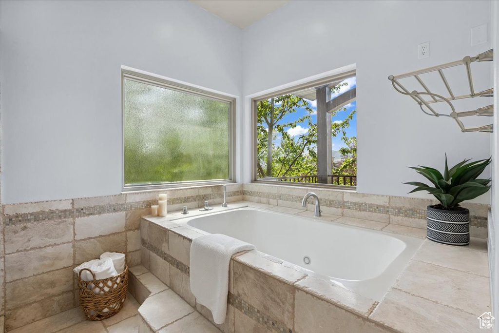 Full bath with plenty of natural light and a whirlpool tub