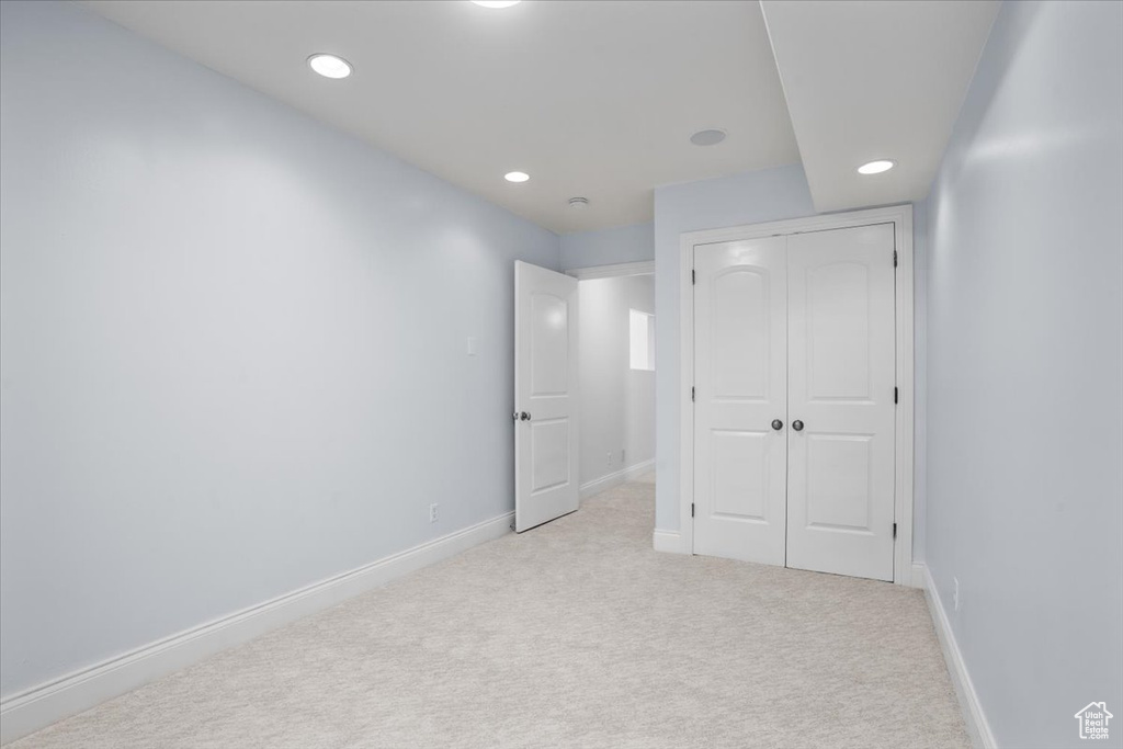 Unfurnished bedroom with carpet flooring, recessed lighting, and a closet