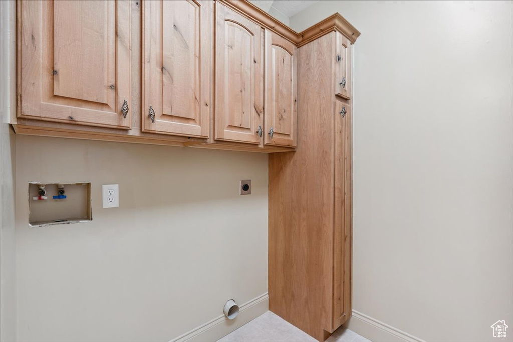 Laundry room featuring hookup for an electric dryer, cabinet space, and hookup for a washing machine