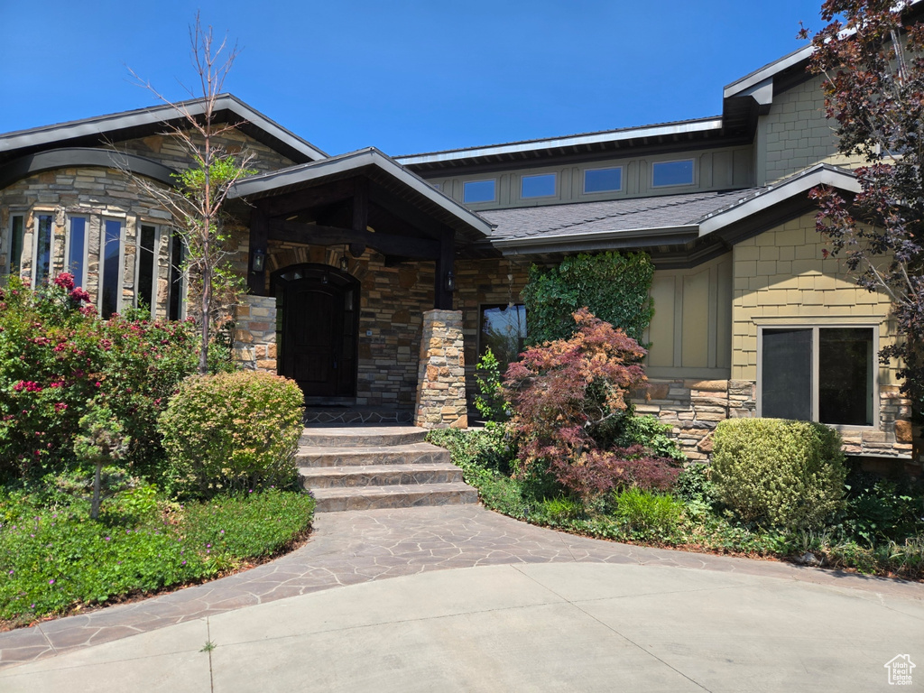 View of front facade with stone siding and board and batten siding