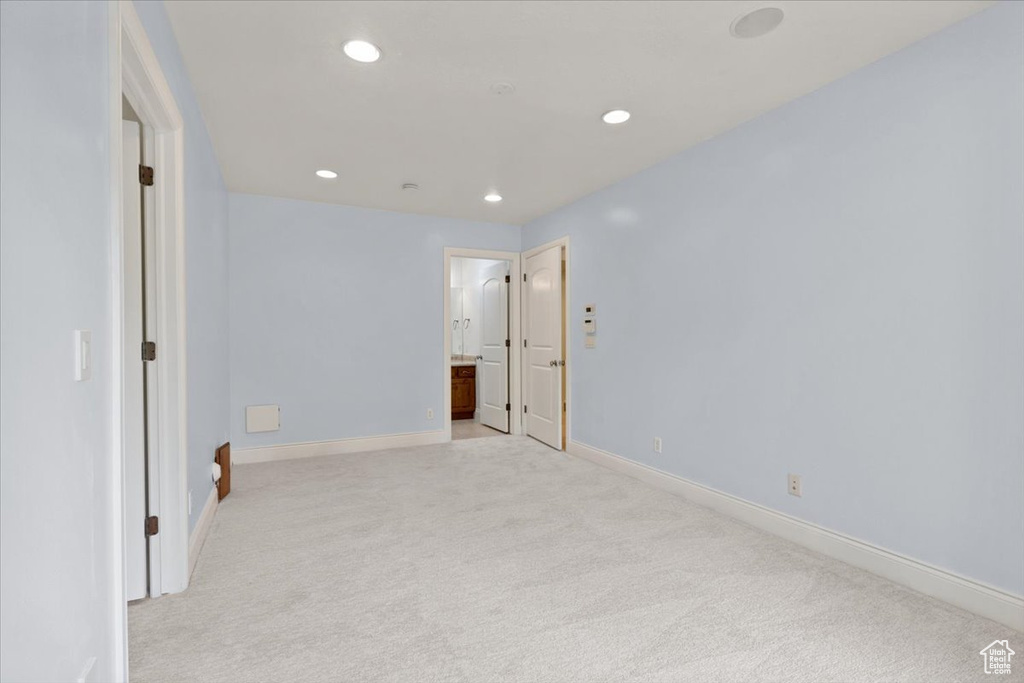 Unfurnished room featuring light carpet and recessed lighting