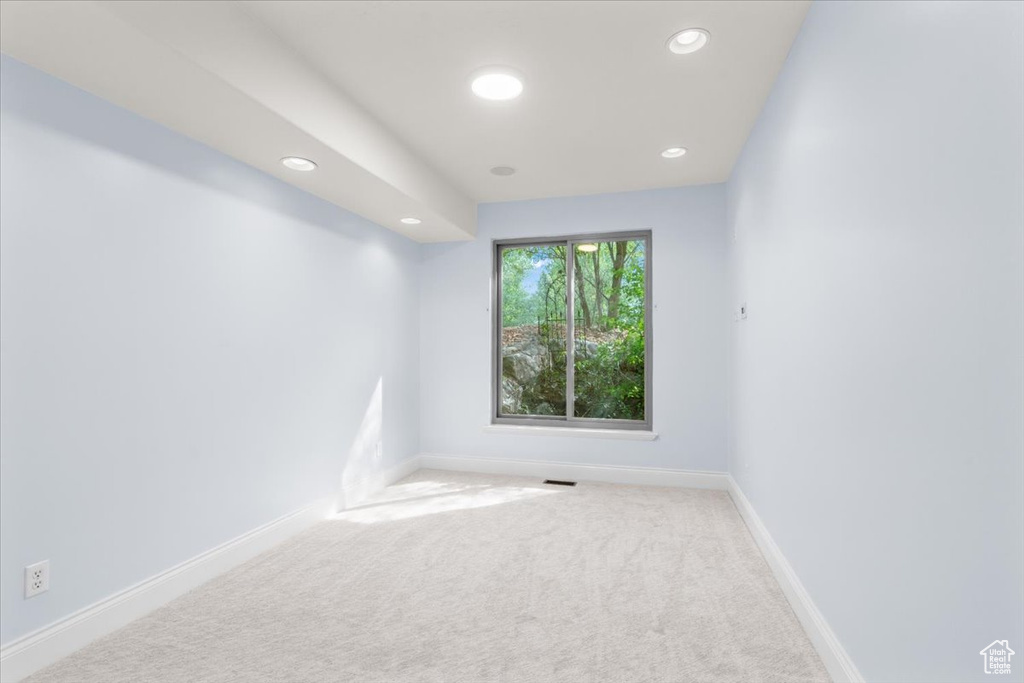Carpeted empty room featuring recessed lighting