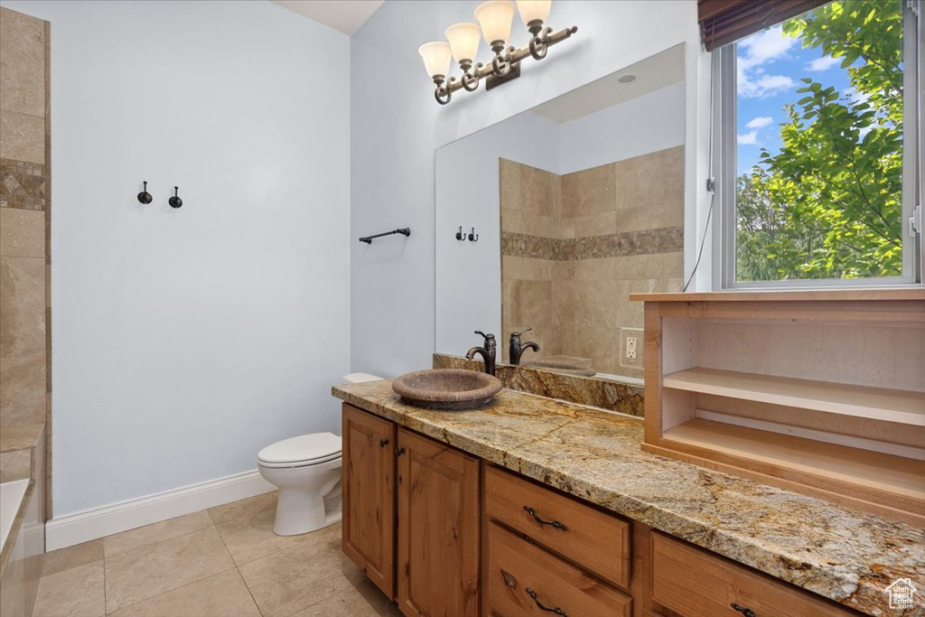 Full bath featuring vanity and tile patterned flooring