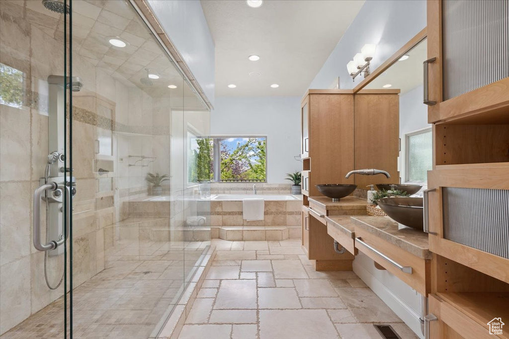 Bathroom with vanity, a bath, a shower stall, and recessed lighting