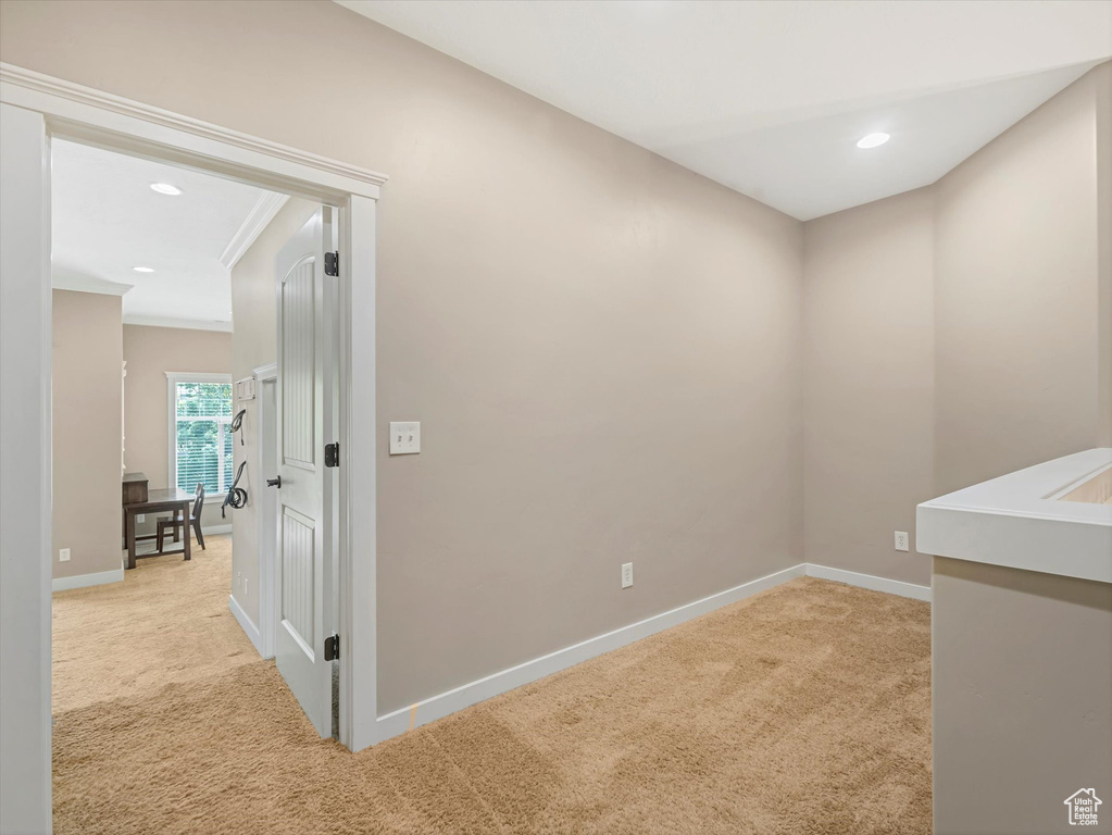 Spare room with light colored carpet, recessed lighting, and crown molding