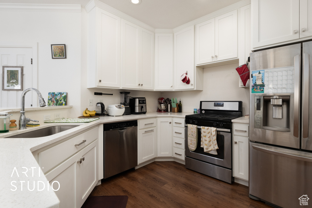 Kitchen featuring appliances with stainless steel finishes, light countertops, white cabinetry, and recessed lighting