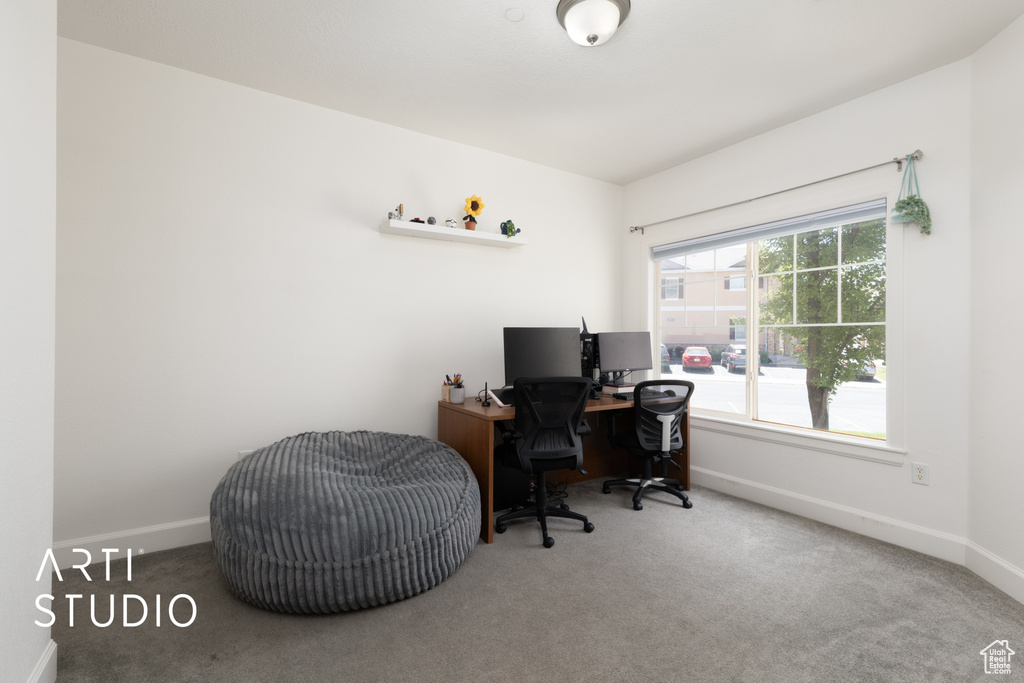 Carpeted office space featuring baseboards