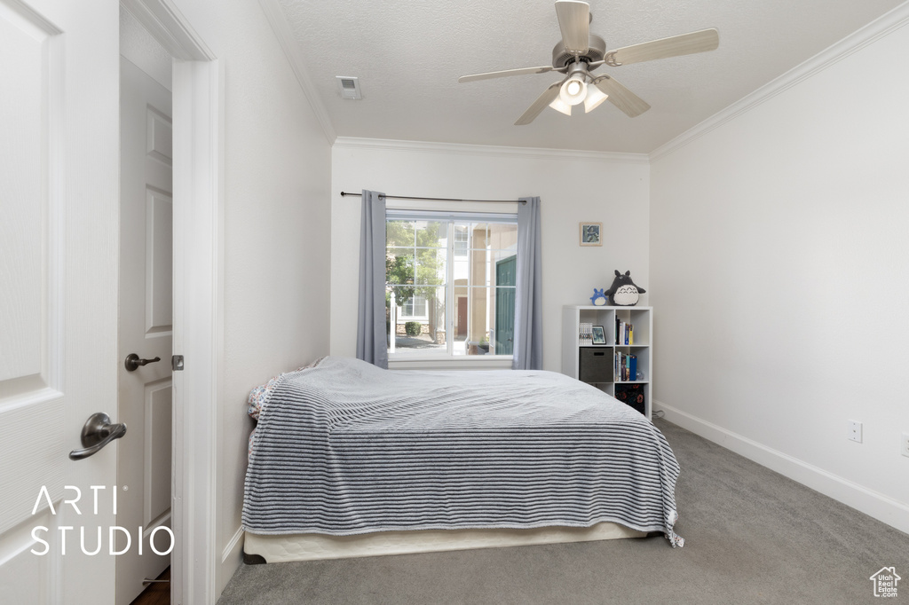 Bedroom featuring crown molding, carpet, and ceiling fan