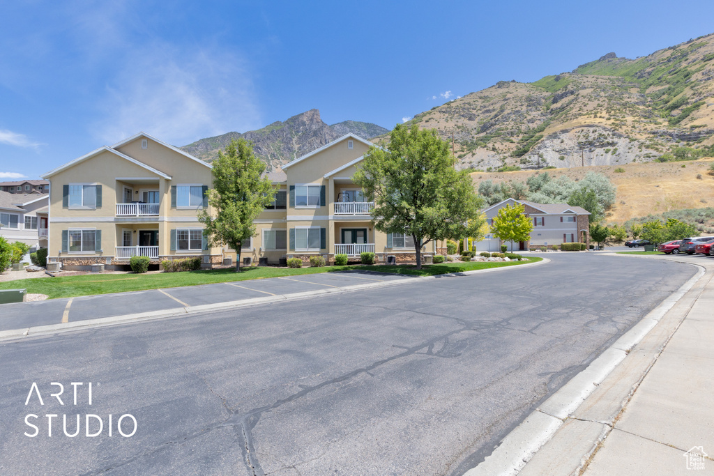 View of property with a mountain view and a residential view