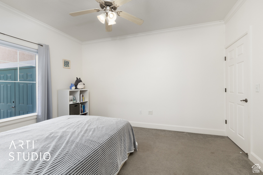 Bedroom featuring ornamental molding, carpet, and ceiling fan