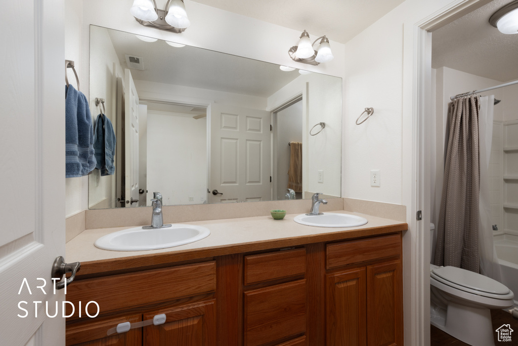 Bathroom with double vanity and shower / bathtub combination with curtain