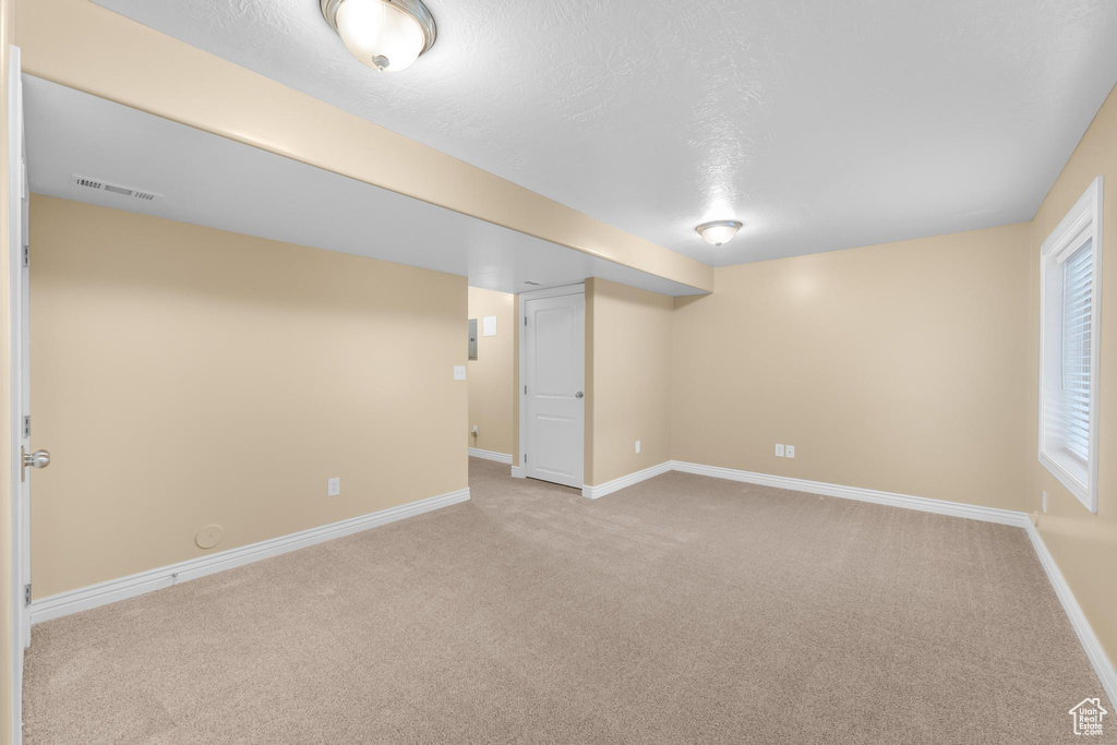 Below grade area with light colored carpet